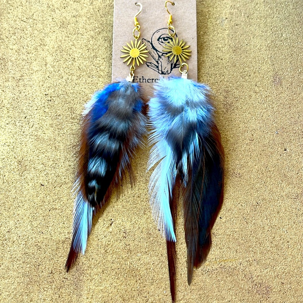Long gray and blue feather earrings with gold flower pendants